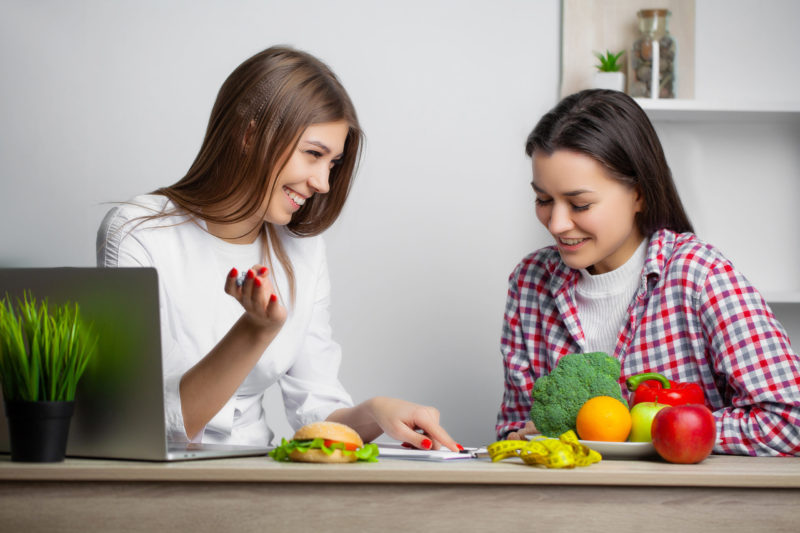 weight loss and functional nutrition, functional nutritionist writing a meal plan for a woman