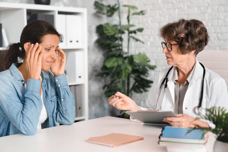 menopause symptoms, woman speaking with doctor about menopause hormone therapy