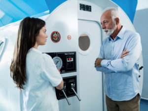 senior man and doctor talking together to illustrate hyperbaric oxygen therapy